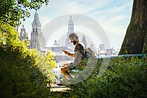 Young Man On Pilgrimage At Santiago De Compostela With Phone