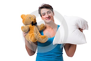 The young man with pillow isolated on white background