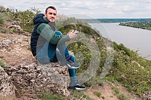 Young man piloting a drone in nature