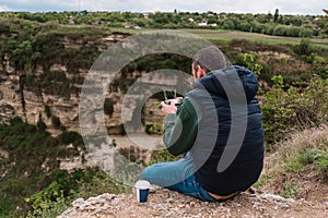 Young man piloting a drone in nature