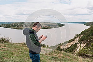 Young man piloting a drone in nature