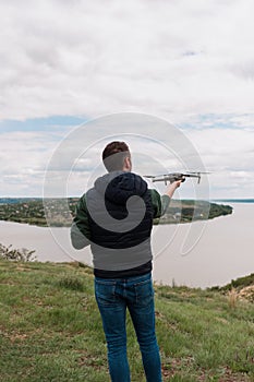 Young man piloting a drone in nature