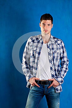 Young man with plaid shirt denim jeans in blue