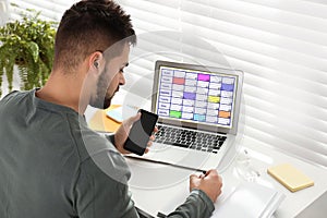 Young man planning his schedule with calendar app on laptop