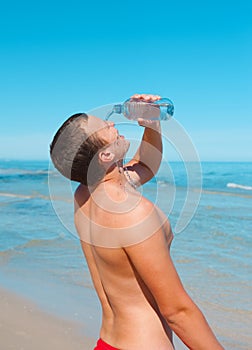 Young man with plastic bottle