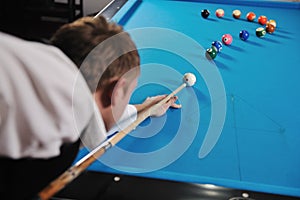 Young man play pro billiard game