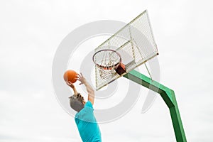 Young man playing basketball outdoors