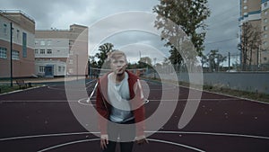 Young man playing basketball outdoors on the court