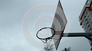 Young man playing basketball outdoors on the court