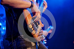 Young man playing bass live. Body.