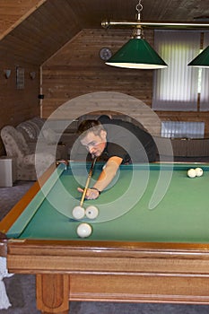 Young man playing billiards
