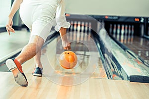 Young man playing bowling.