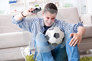 The young man playing computer games at home