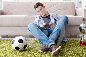 The young man playing computer games at home