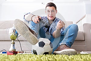 The young man playing computer games at home