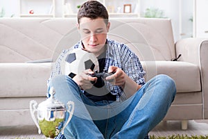 The young man playing computer games at home