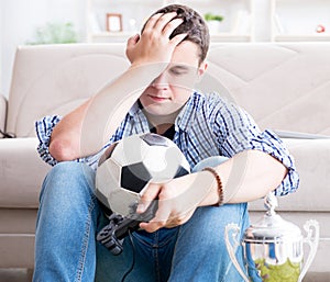 Young man playing computer games at home