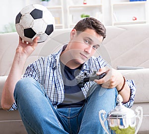 Young man playing computer games at home