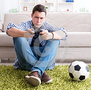 Young man playing computer games at home