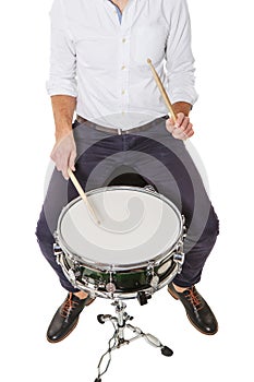 Young man playing on a drum