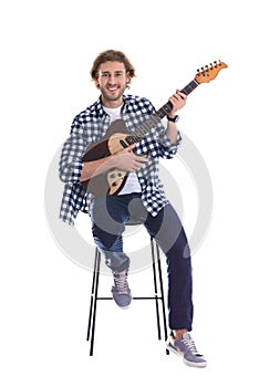 Young man playing electric guitar on white