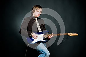 Young man playing electro guitar