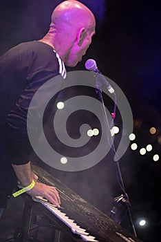 Young man playing electronic keyboard.