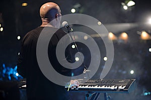 Young man playing electronic keyboard.