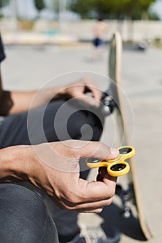 Young man playing with a fidget spinner