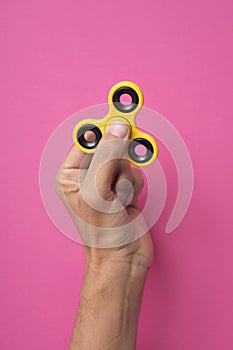 Young man playing with a fidget spinner