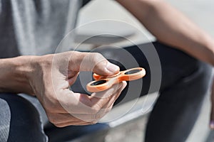 Young man playing with a fidget spinner photo