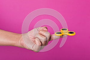 Young man playing with a fidget spinner photo