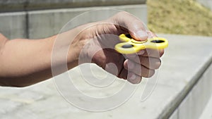 Young man playing with a fidget spinning