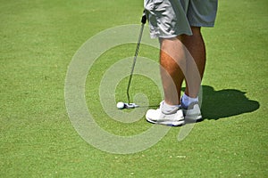 Young Man Playing Golf making a Putt