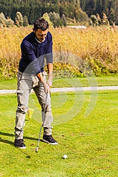 Young man playing golf