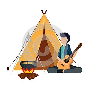 young man playing guitar with camping tent and woodfire