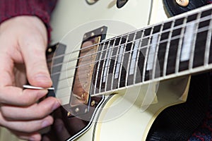 A young man playing guitar