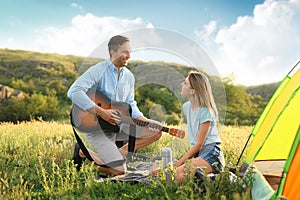 Young man playing guitar for his girlfriend