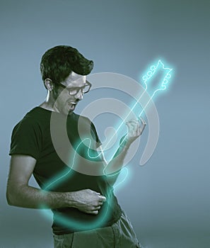 Young man playing imaginary guitar and squealing