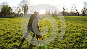 Young man playing outdoors with his purebred border collie dog