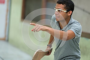 Young man playing pelota wearing eye protection photo