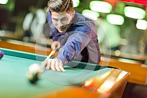 Young man playing pool