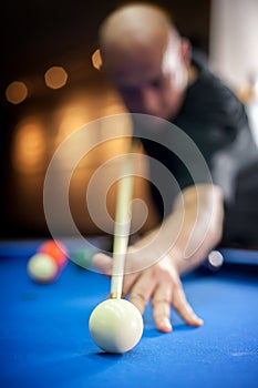 Young man playing pool game in pub