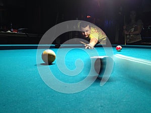 Young man playing pool