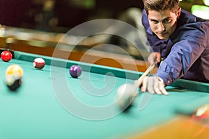 Young man playing pool