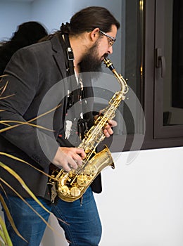 young man playing saxophone