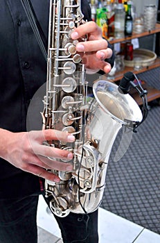 Young man playing the saxophone at the wedding