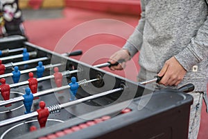 Young man playing tablefootball in the park in moscow