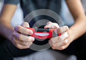 Young man playing video game with gamepad front view