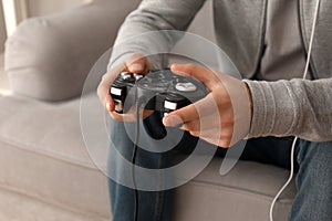 Young man playing video games at home